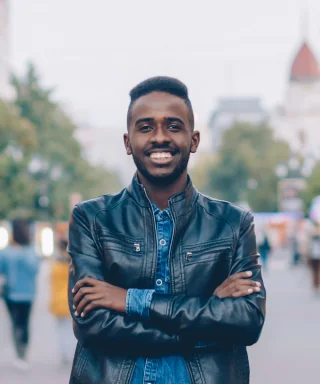 Sample portrait of a smiling man in a leather jacket outdoors