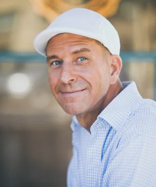 Sample portrait of a smiling man wearing a cap